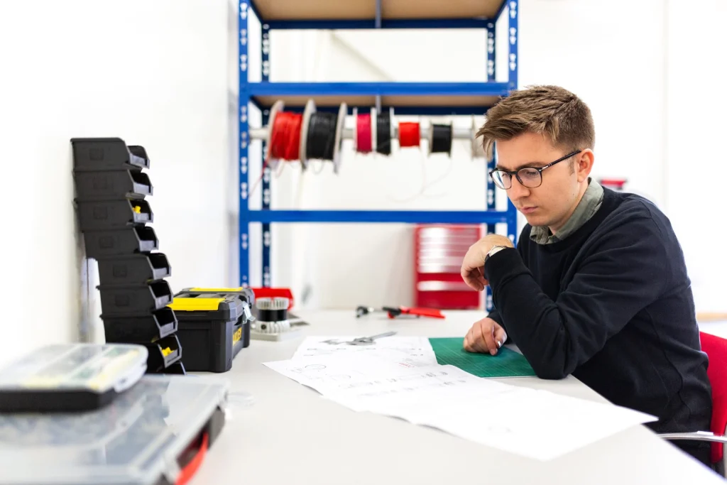 Engineer looking at paper blueprint drawings